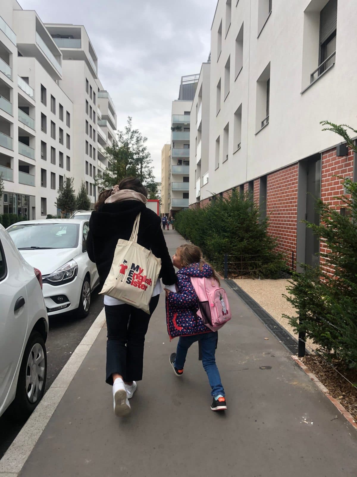 An assistant walking a child home from school